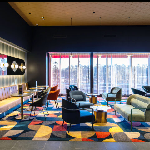 A richly layered lounge setting defined by colour, texture and a cinematic sense of occasion.